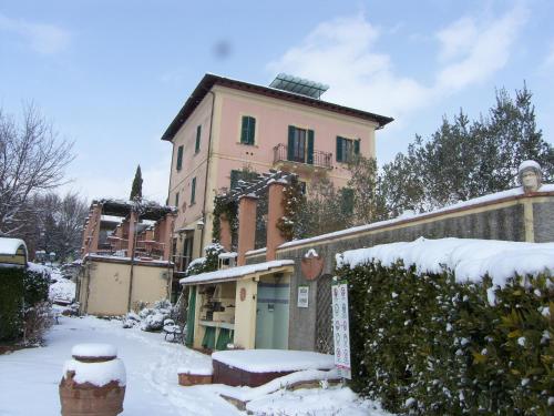 a house with snow on the ground in front of it at Domus Volumnia Country House in Perugia