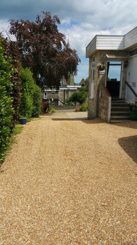 a gravel driveway in front of a house at Victoria Lodge in Shanklin