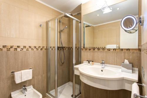 a bathroom with a sink and a shower at Hotel Indigo Verona - Grand Hotel Des Arts by IHG in Verona