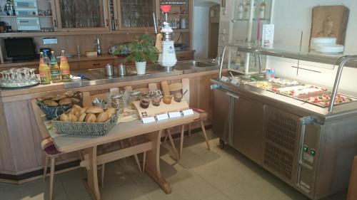a kitchen with a counter with a table with food at Landgasthof und Pension Zum löwen in Bischofsheim an der Rhön