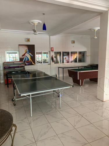 a room with two ping pong tables and a pool table at Woodpecker Resort Hotel in Bathurst