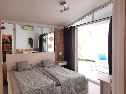 a bedroom with two beds and a large window at Bungalow 2-7 Playa del Ingles in Playa del Ingles