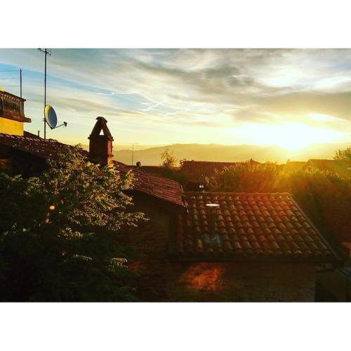 a view of the sunset from the roof of a building at Casa Baladin camere di Charme e Agronidi dell'Open Garden in Piozzo
