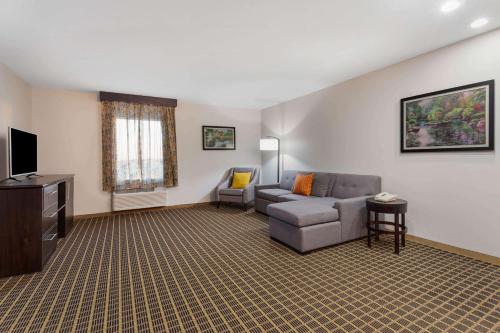 a living room with a couch and a tv at La Quinta by Wyndham Rockford in Rockford