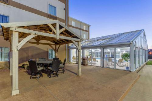 a pavilion with a table and chairs on a patio at La Quinta by Wyndham Rockford in Rockford