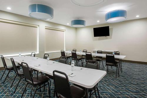 a conference room with tables and chairs and a tv at La Quinta by Wyndham Lake Charles - Westlake in Westlake