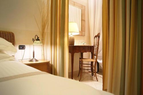 a bedroom with a desk and a bed and a chair at Locanda A Cà Du Gigante in Monterosso al Mare