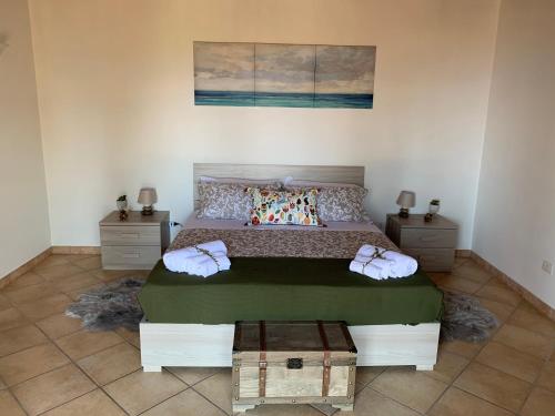 a bedroom with a large bed and two night stands at Villa Mimma in Taormina