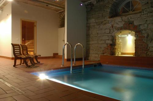 a swimming pool in a room with a brick wall at 16eur - Fat Margaret's in Tallinn