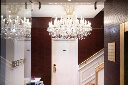 a chandelier hanging over a door in a room at Hôtel Merveilleux Côté Mer in Dunkerque