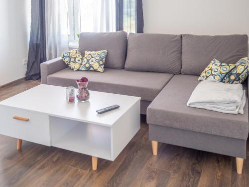 a living room with a couch and a coffee table at Relaxcentrum Ľudmila in Cabaj-Čápor