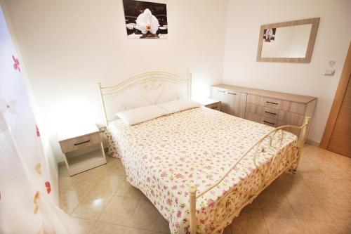 a bedroom with a bed with a white bedspread at Bilocale Orange in Gallipoli