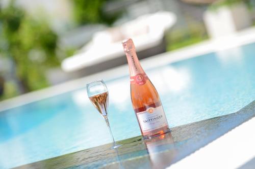 a bottle of wine and a glass on a table at Aura Hotel Adults Only in Balatonfüred