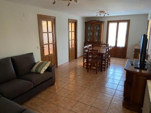 a living room with a couch and a table at CASA PEDRO BERGUA in Fiscal