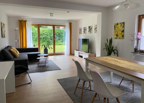a living room with a table and chairs and a couch at Fuchsbau-Goldbach in Goldbach