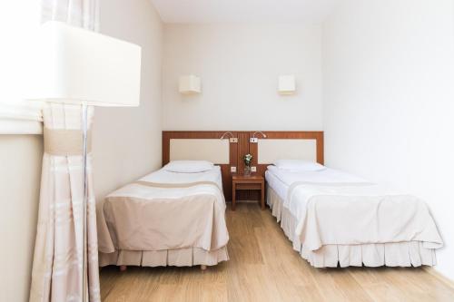 Cama o camas de una habitación en Hotel Osada Karbówko Wellness & SPA