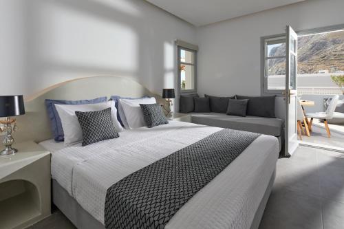 a bedroom with a large bed and a couch at Blue Sea Hotel in Kamari