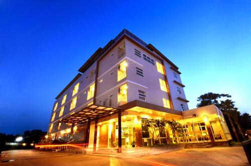a large white building with lights on at The Bliss Loei Living in Loei