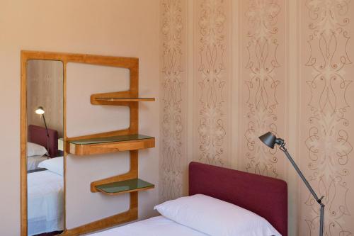 a bedroom with a ladder and a bed and a mirror at Distilia Dimora Salentina in San Cesario di Lecce