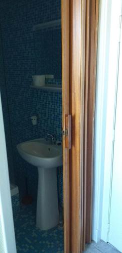 a bathroom with a sink and a white sink at hotel Melissa in Péruwelz