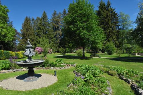a fountain in the middle of a garden at Parkhotel Adler in Hinterzarten