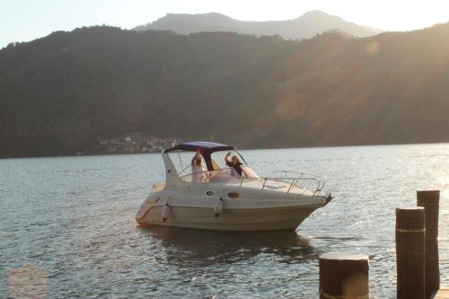 two people in a boat on the water at Campeggio Punta di Crabbia in Pettenasco