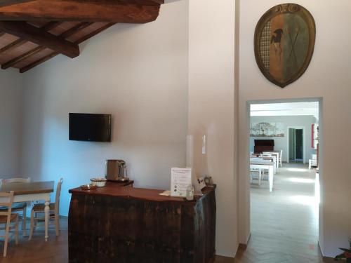 a room with a table and chairs and a clock on the wall at Il Mulino di Celle in Pistoia