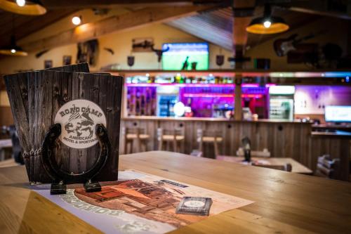 a coffee cup sitting on a table in a bar at Roadcamp - American Motel & Sportsbar in Marl