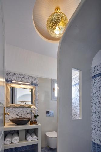 a bathroom with a sink and a mirror at Blue Sea Hotel in Kamari