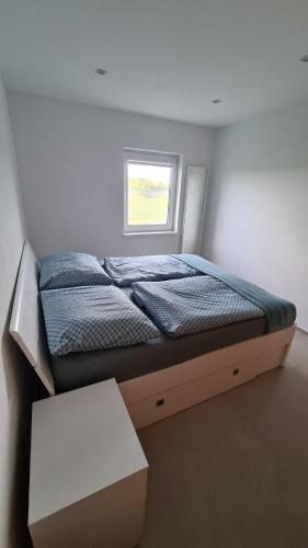 a small bedroom with a bed and a window at Apartment MINT in Senec