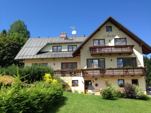 a large house with a balcony on top of it at Apartmany Aneta in Špindlerův Mlýn