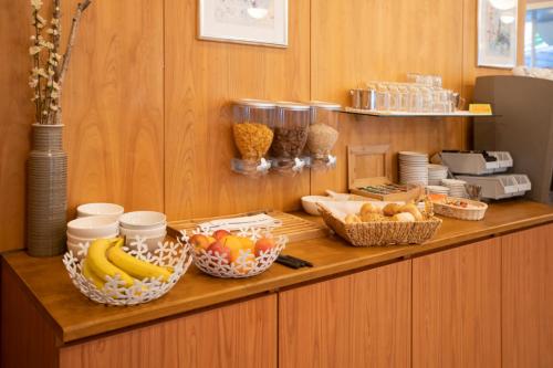 a counter with fruits and baskets of food on it at Hotel Rotes Kreuz in Arbon