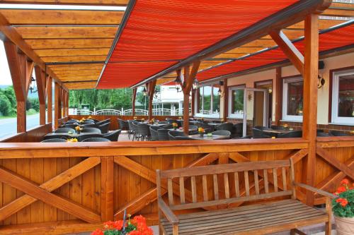 an outdoor patio with tables and chairs at Hotel im Rheintal in Kamp-Bornhofen