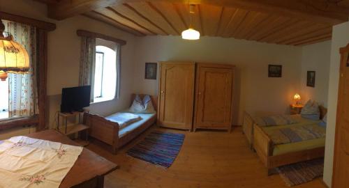 a living room with a bed and a couch at Biohof Grissenberger in Abetzdorf