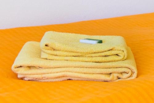 a stack of towels with a cell phone on top at Hotel Rotes Kreuz in Arbon