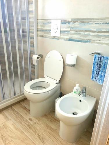 a bathroom with a toilet and a sink at Apartment Mary in Terracina