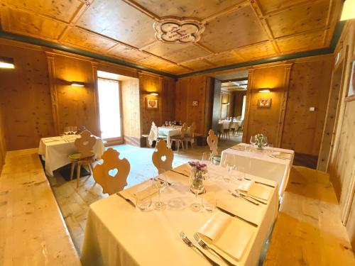 a dining room with two tables in a room with at Rifugio Ospitale in Cortina dʼAmpezzo