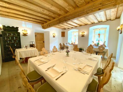a large dining room with a table and chairs at Rifugio Ospitale in Cortina dʼAmpezzo