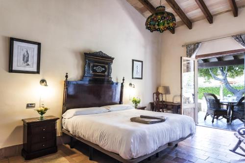 a bedroom with a large bed and a table at Aumallia Hotel & Spa in Felanitx