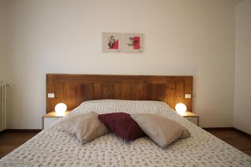 a bedroom with a bed with two pillows on it at Lovely Panoramic View Apartment - Affitti Brevi Italia in Aosta