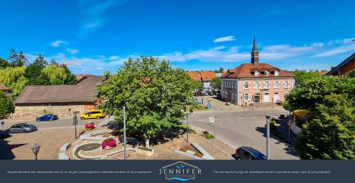 a large building with a steeple on top of a street at Ferienwohnung Jennifer in Rust