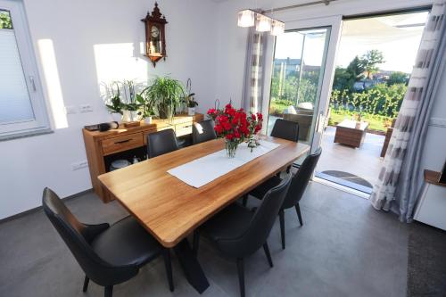 a dining room with a wooden table and chairs at Hisa dobrega pocutja in Kozina