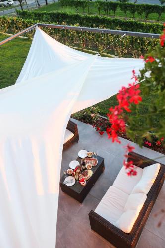 a table with plates of food and a white tent at Hisa dobrega pocutja in Kozina