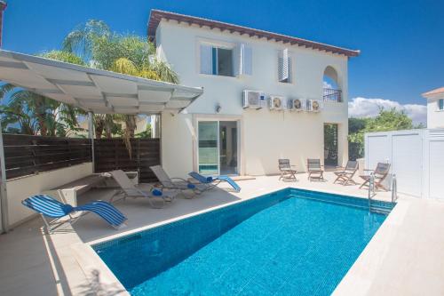 a villa with a swimming pool and a house at Katerina Luxury Villas in Protaras