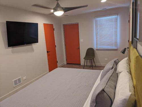 a living room with a couch and a flat screen tv at 4411 Inn & Suites in Michigan City