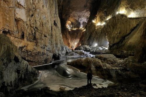a man is standing in a cave with snow at Hisa dobrega pocutja in Kozina