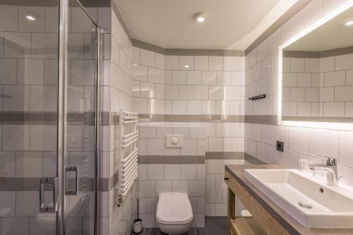 a bathroom with a toilet and a sink and a shower at Pointe Isabelle in Chamonix-Mont-Blanc