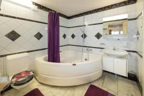 een badkamer met een bad, een wastafel en een toilet bij Anna 1 in Grächen