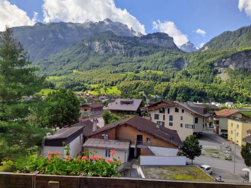 a town with mountains in the background at Hotel Sherlock Holmes & Khana Restaurant "200 m Gondola to Hasliberg ski" in Meiringen