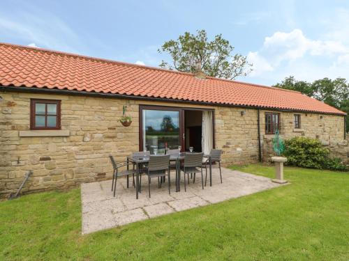 a table and chairs in front of a stone house at Ellaberry in Darlington